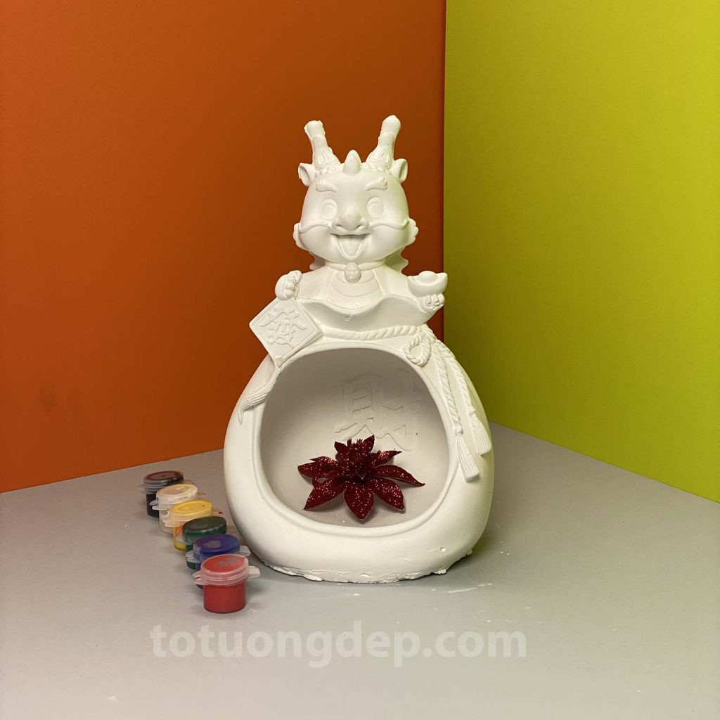 Tượng rồng thần tài đang được tô màu, mang ý nghĩa may mắn và tài lộc